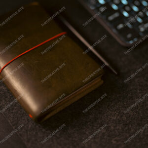 Parisian Leather Journal Beside Laptop Keyboard