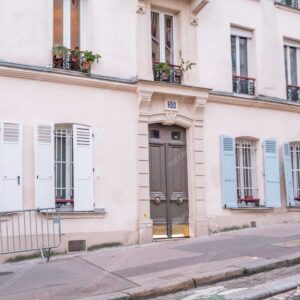 Parisian Building With Blue And White Shutters On Quiet Street