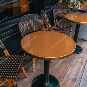 Black Parisian Café Chairs And Gold Tables Outdoors