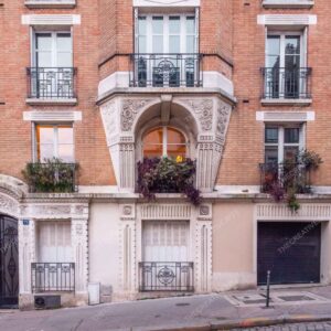 Paris Red Brick Facade With Ornate Balcony And Flowers