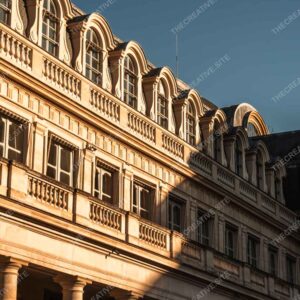 Golden Parisian Facade With Sunlit Arched Windows