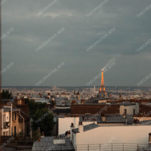 Eiffel Tower Sparkling Over Paris Rooftops At Night