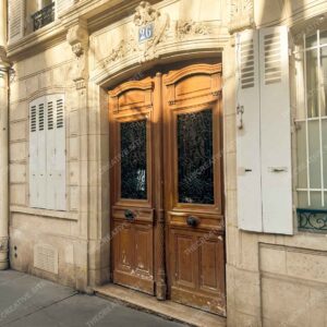Historic Paris Building With Ornate Door And Shutters